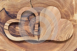 Two wooden hearts on a wooden background