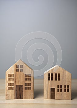 Two wooden houses, figures. Good neighborliness. Neighbours. photo