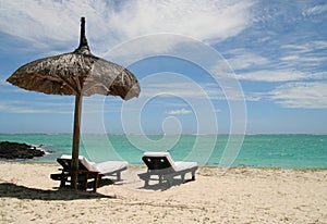 Two wooden lie on the beach in Mauritius