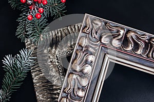 Two wooden picture frames on black background. Christmas decor.