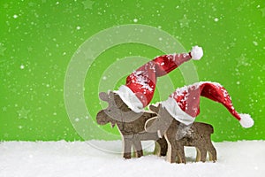 Two wooden reindeer: funny green and white christmas background.