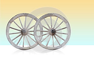 two wooden and rust steel wagon wheel on gradient yellow and blue background, object, vintage, transport, decor, copy space