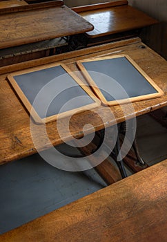 Two Wooden Slates on Line of School Desks