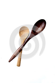 Two wooden spoon on white background