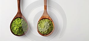 Two wooden spoons with ground green tea powder, green matcha powder, antioxidant on a white background, top view.