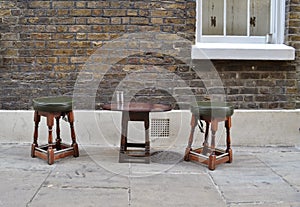 Two wooden stools and a small table