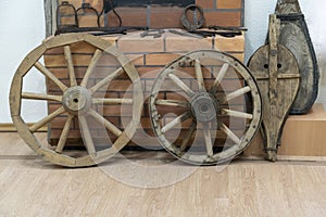 Two wooden wheels from the diagram on the background of a brick smithy, fur to inflate the fire in the fireplace overall plan