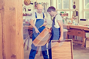 Two worker in a carpenter`s workshop