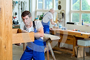 Two worker in a carpenter's workshop