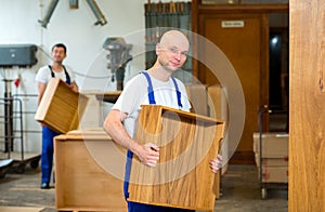 Two worker in a carpenter's workshop