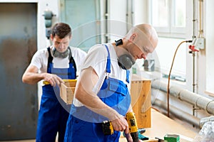 Two worker in a carpenter's workshop