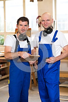 Two worker in a carpenter's workshop