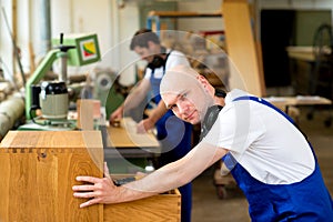 Two worker in a carpenter's workshop