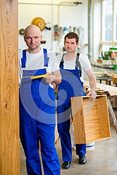 Two worker in a carpenter's workshop