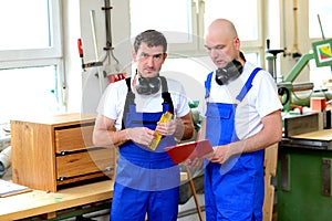 Two worker in a carpenter's workshop