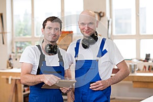 Two worker in a carpenter's workshop