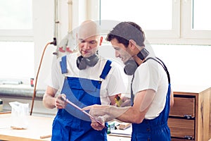 Two worker in a carpenter's workshop