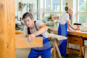 Two worker in a carpenter's workshop