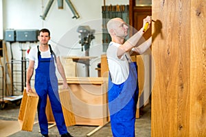 Two worker in a carpenter's workshop