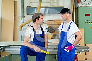 Two worker in a carpenter's workshop
