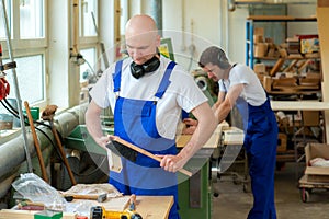 Two worker in a carpenter's workshop