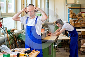 Two worker in a carpenter's workshop