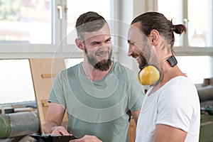 Two worker in a carpenter`s workshop