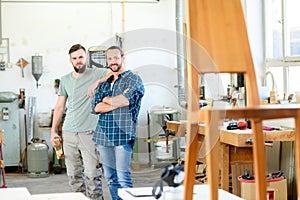 Two worker in a carpenter`s workshop