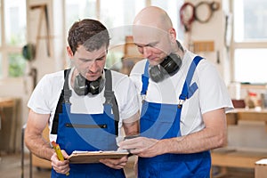 Two worker in a carpenter's workshop