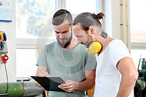 Two worker in a carpenters workshop