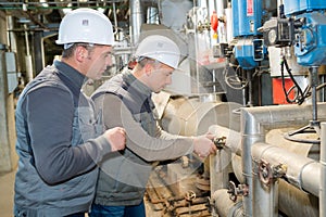 Two worker in factory on machine