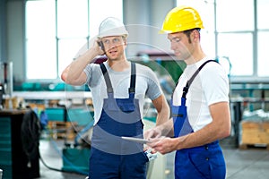 Two worker with phone and tablet PC