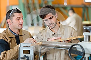 Two workers in carpenters workshop