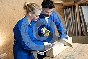Two workers in carpentry workshop