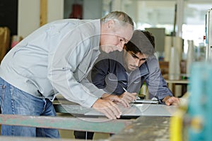 two workers choosing pvc aluminium window profile at stand