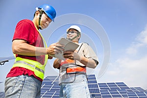 Two workers discussing with tablet