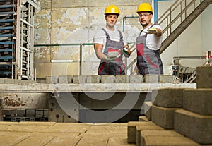 Two workers on a factory