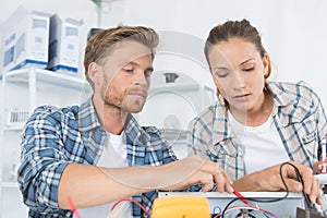 two workers holding multimeter checking voltage