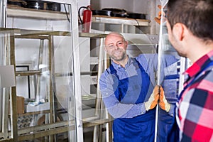 Two workers inspecting windows