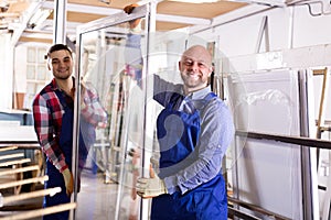 Two workers inspecting windows