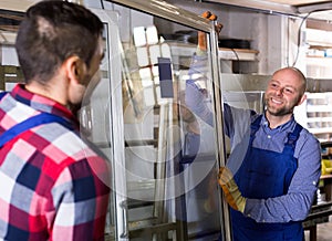 Two workers inspecting windows