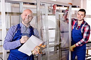 Two workers inspecting windows