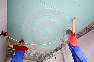 Two workers are mounted ceiling in the new photo