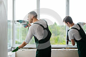 Workers are mounting a window