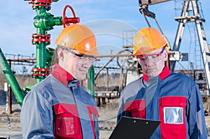 Two workers in the oilfield