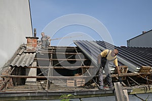 Two workers roofer builder working on roof structure on construction site