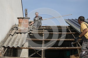 Two workers roofer builder working on roof structure on construction site