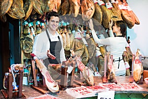 Two workers selling jamon