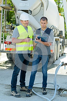 Two workers standing on guardrail