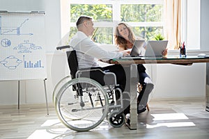 Two Workers Using Laptop Working Together
